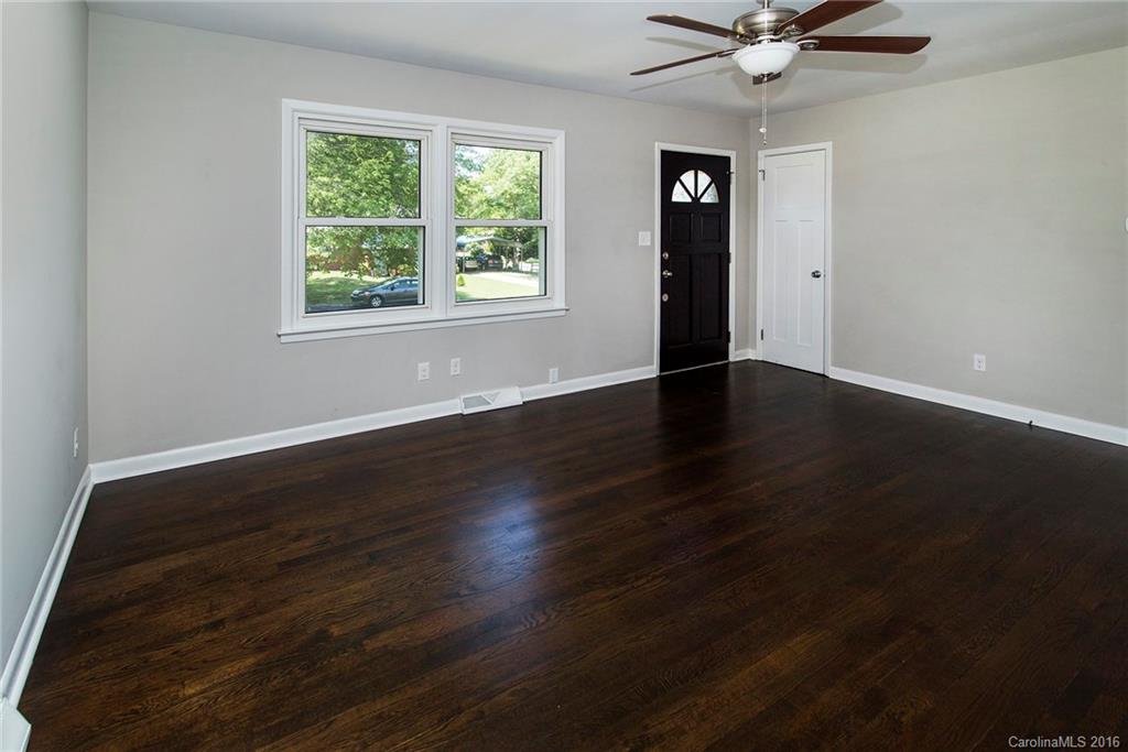 4209 Woodleaf Road Charlotte, NC 28205 - Photo 5 of 18 a view of an empty room with wooden floor and a window