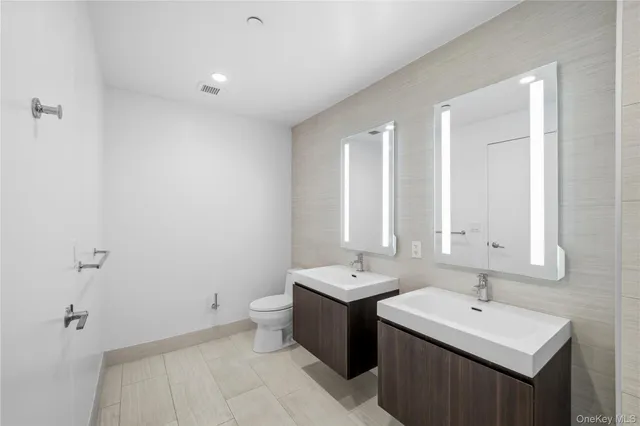 a bathroom with 2 sink and a mirror