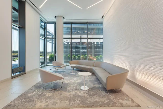 a living room with furniture and large windows