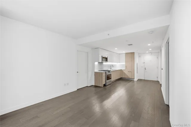 a view of a room with wooden floor and furniture