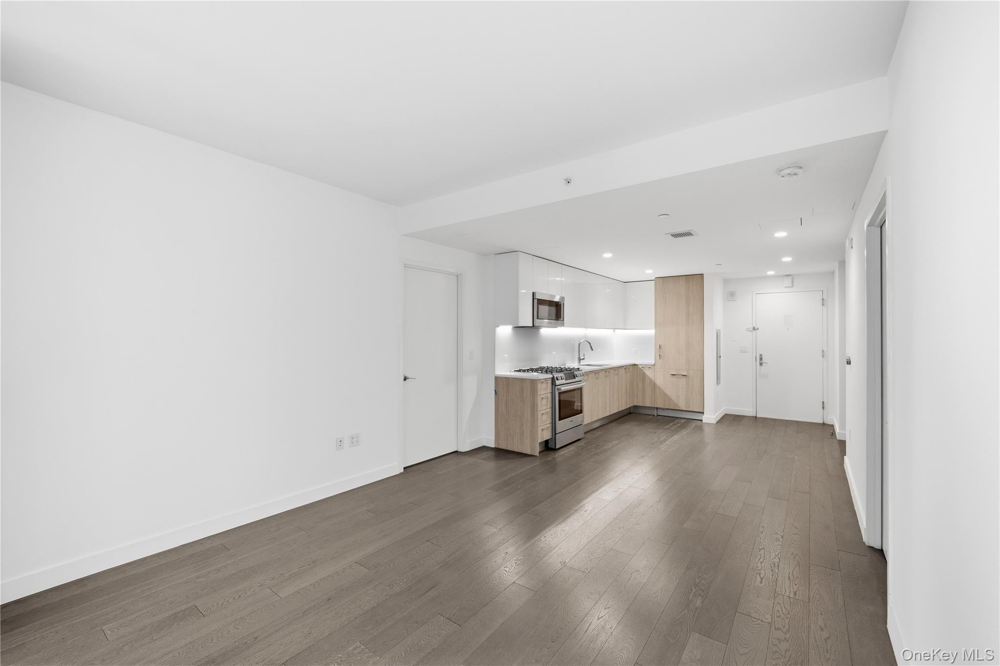 131-03 40 Road, Unit 11Q Queens, NY 11354 - Photo 3 of 31 a view of a room with wooden floor and furniture