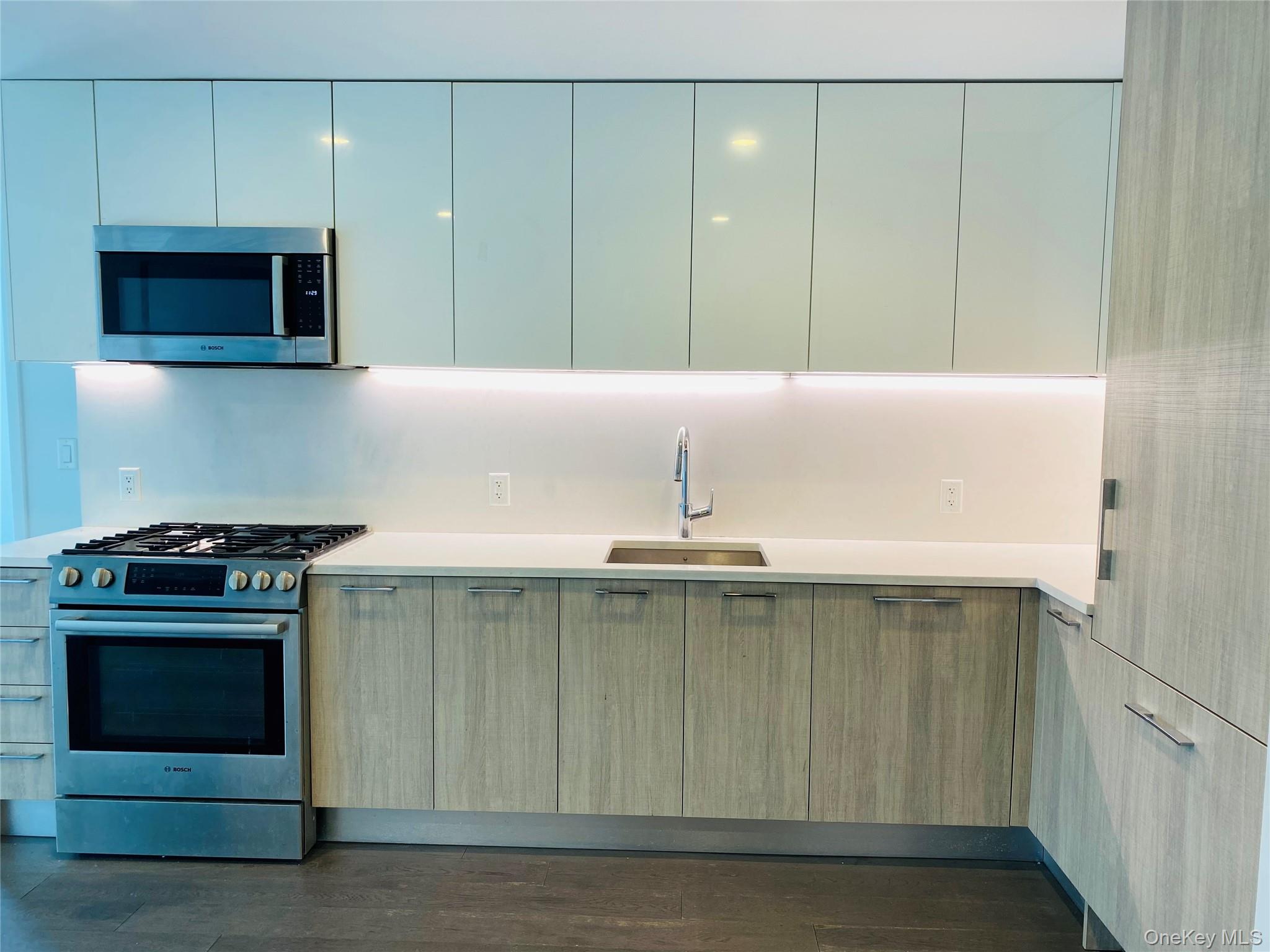 131-03 40 Road, Unit 11Q Queens, NY 11354 - Photo 4 of 26 a kitchen with a sink and a stove top oven