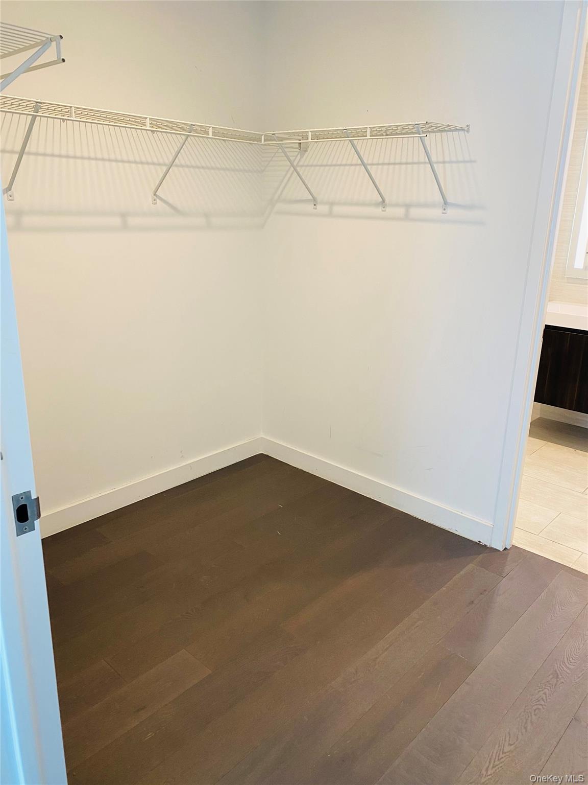 131-03 40 Road, Unit 11Q Queens, NY 11354 - Photo 7 of 26 a view of a room with racks on the wall