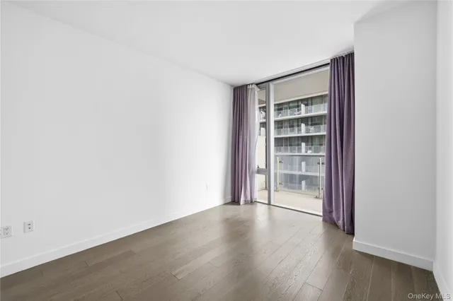 a view of wooden floor and windows in a room