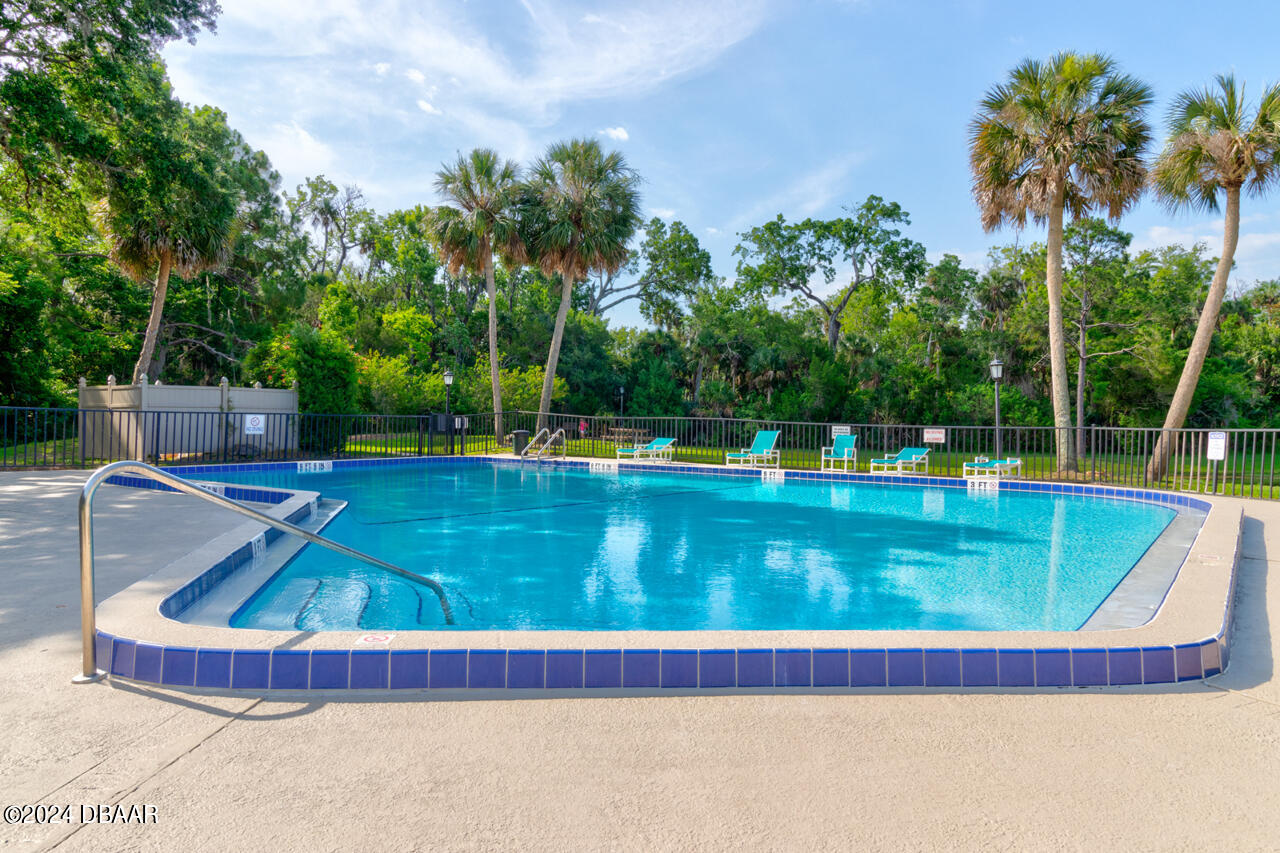 13 Glen Arbor Park Ormond Beach, FL 32174 - Photo 24 of 35 a view of a swimming pool with a yard