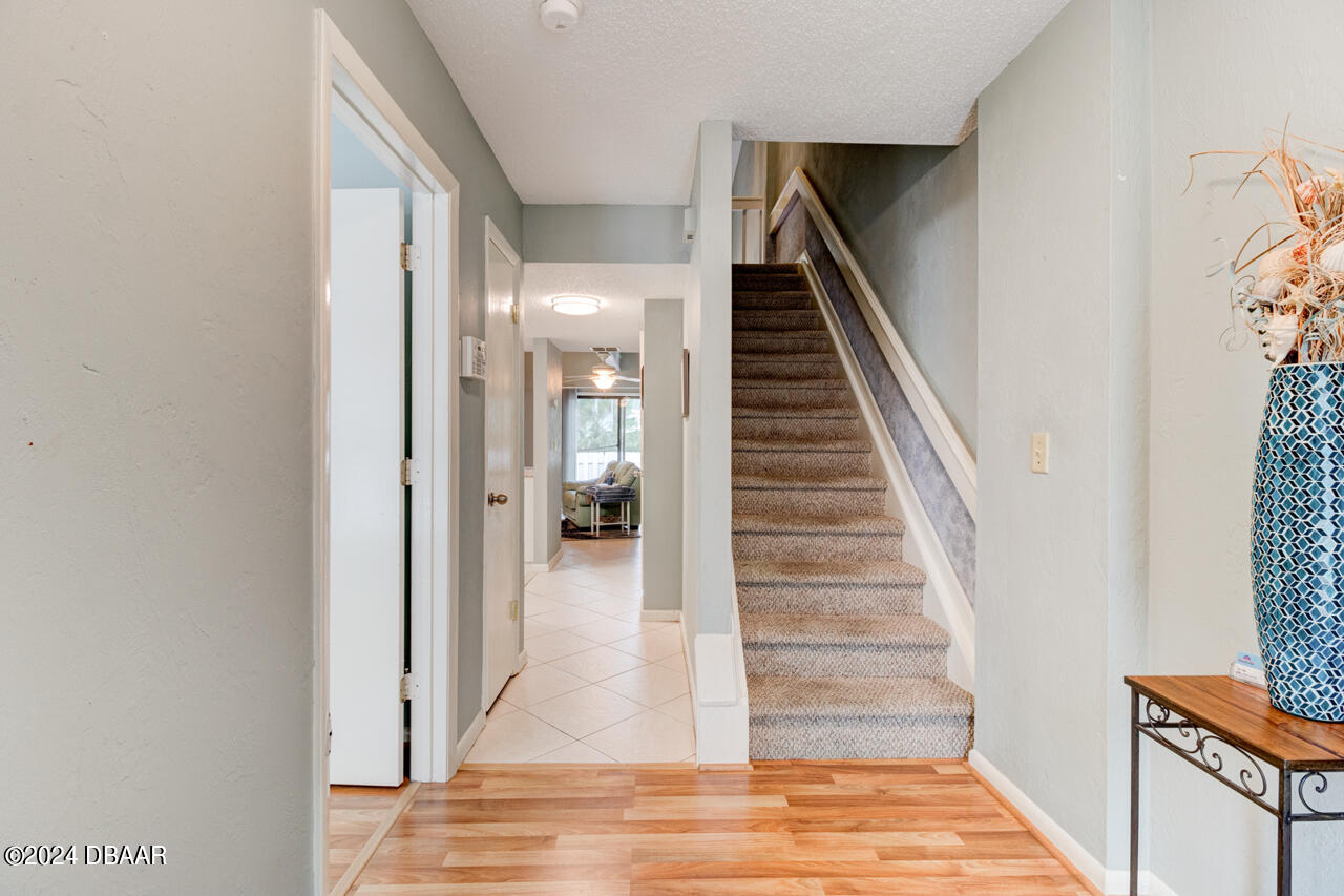 13 Glen Arbor Park Ormond Beach, FL 32174 - Photo 5 of 35 a view of a hallway with wooden floor and staircase