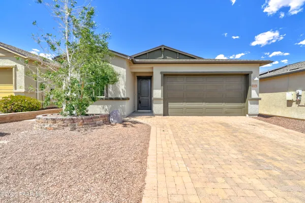 a view of a house with a yard and garage