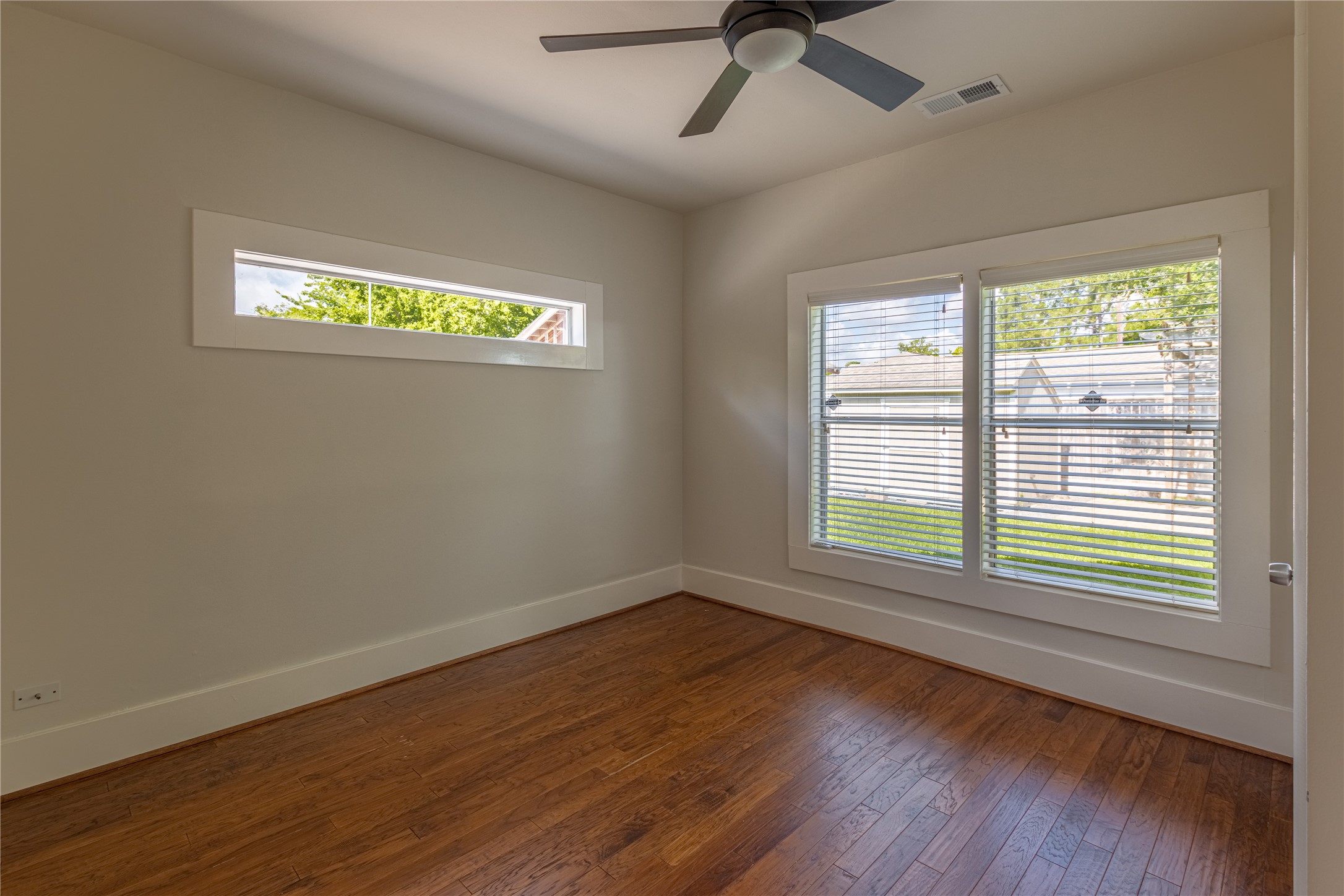 2009 Singleton Street Houston, TX 77008 - Photo 18 of 24 a view of an empty room with a window and wooden floor