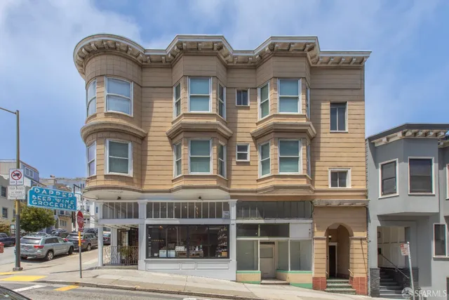a front view of a residential apartment building with a yard