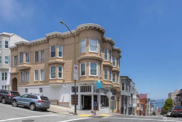 a front view of a residential apartment building with a yard