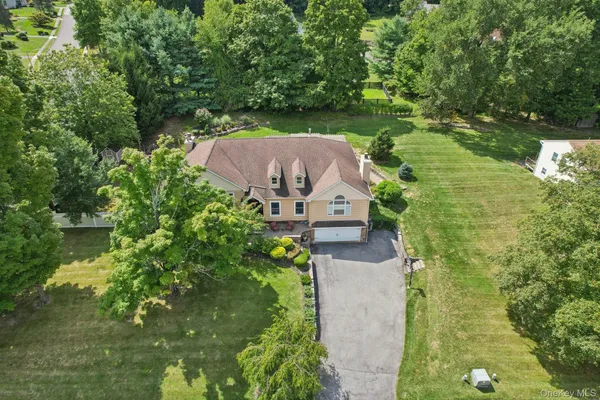 an aerial view of a house with a yard basket ball court and outdoor seating