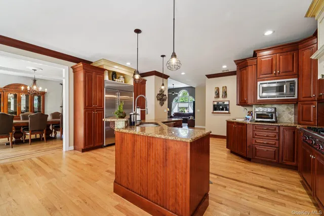 a kitchen with stainless steel appliances granite countertop a stove a sink dishwasher and a refrigerator