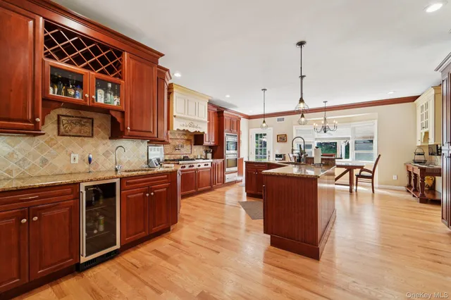 a large kitchen with stainless steel appliances granite countertop a stove and cabinets