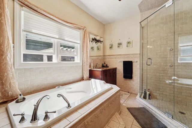 a bathroom with a tub sink and shower