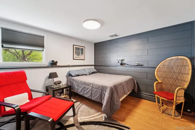 a bedroom with a bed a table and chair