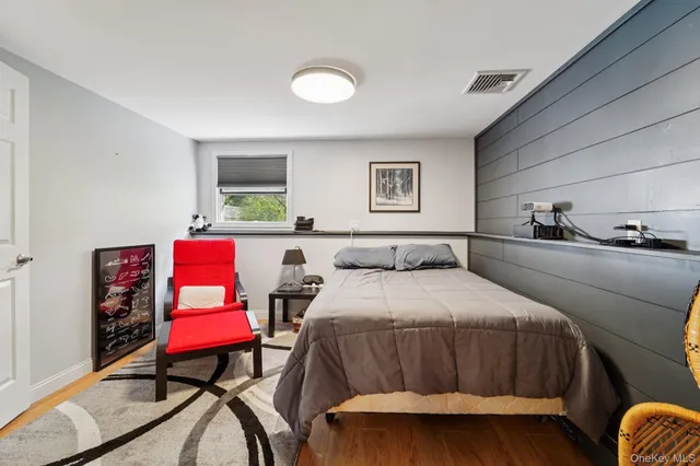 a bedroom with a bed a table and chair