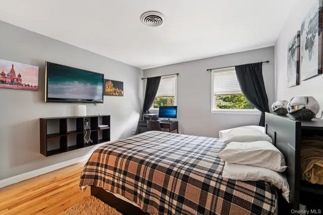 a bedroom with a bed and a flat screen tv