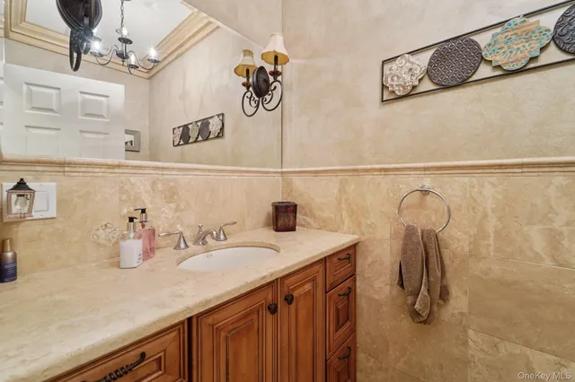 a bathroom with a sink vanity and mirror