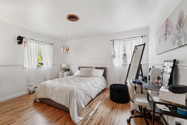 a bedroom with a bed a window and chair