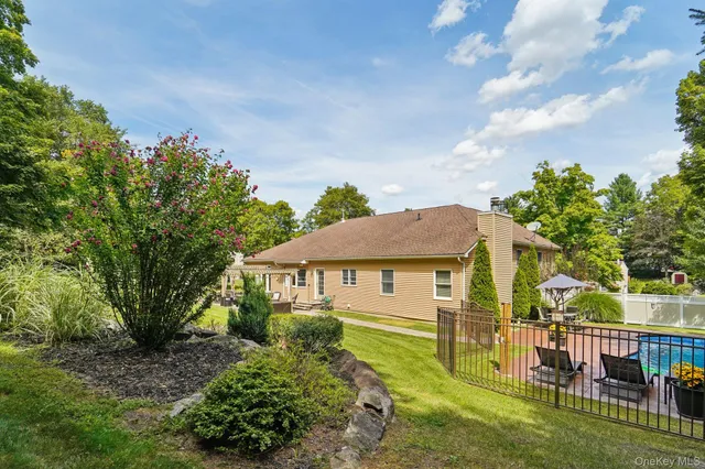 a view of an house with backyard space and balcony