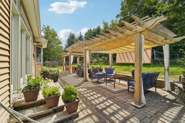 a view of a patio with table and chairs potted plants