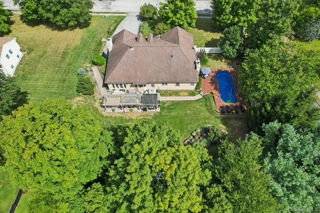 an aerial view of a house with a yard