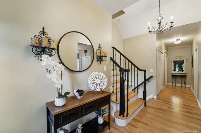 a view of a hallway with wooden floor and entryway