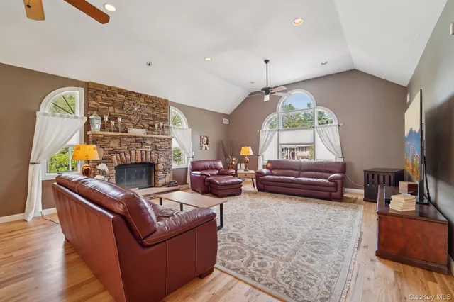 a living room with furniture a fireplace and a flat screen tv