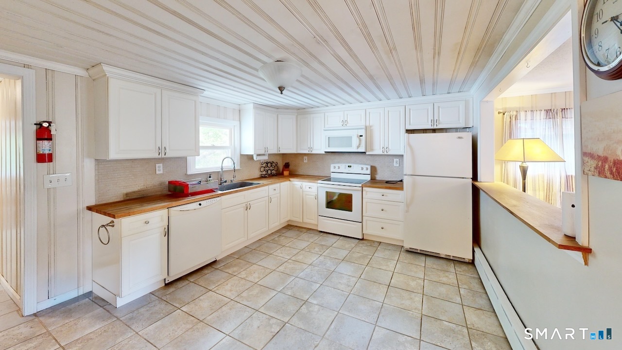 88 Avery Avenue Meriden, CT 06450 - Photo 9 of 31 a kitchen with cabinets a sink and white appliances