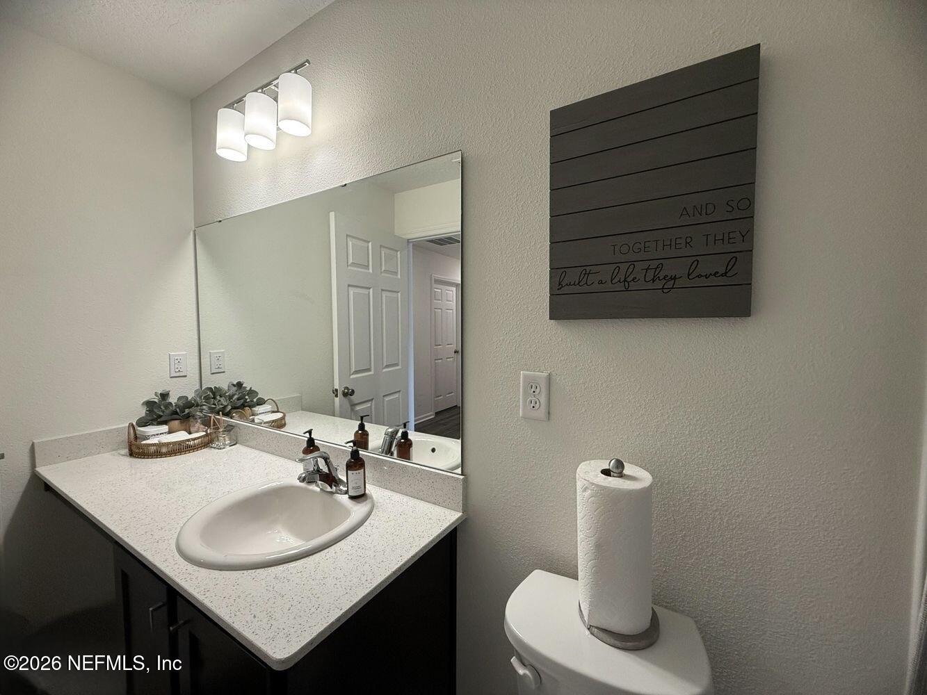 8161 Lumber Way Jacksonville, FL 32222 - Photo 11 of 13 a bathroom with a sink and a mirror