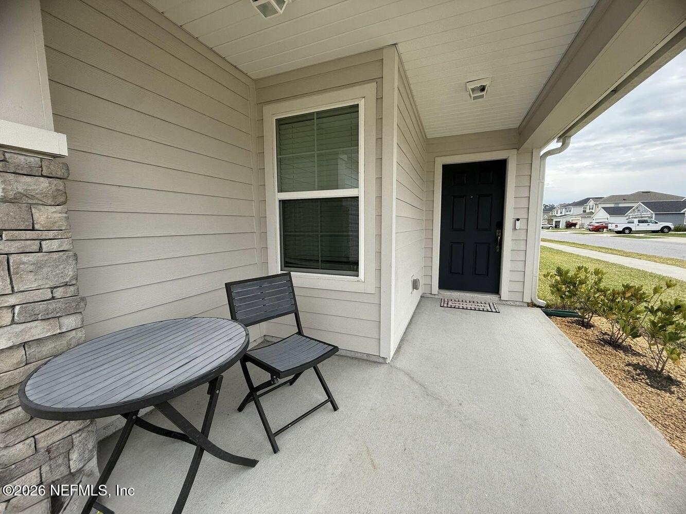 8161 Lumber Way Jacksonville, FL 32222 - Photo 3 of 13 a view of a porch with furniture and a yard