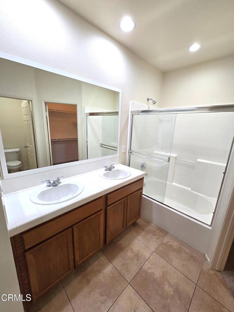 3319 North Ventura Road Oxnard, CA 93036 - Photo 17 of 25 a bathroom with a double vanity sink a mirror and a bathtub