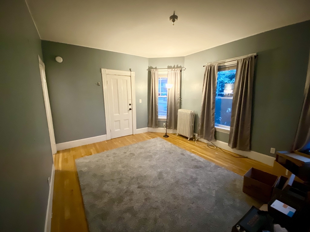 12 Highland Avenue, Unit 2 Beverly, MA 01915 - Photo 1 of 7 a bedroom with a bed and a dresser