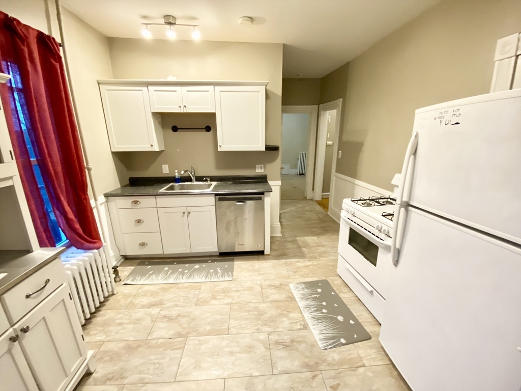 12 Highland Avenue, Unit 2 Beverly, MA 01915 - Photo 3 of 7 a kitchen with a stove a refrigerator and a stove