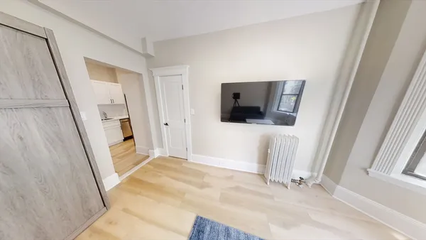 a view of a livingroom with wooden floor and staircase