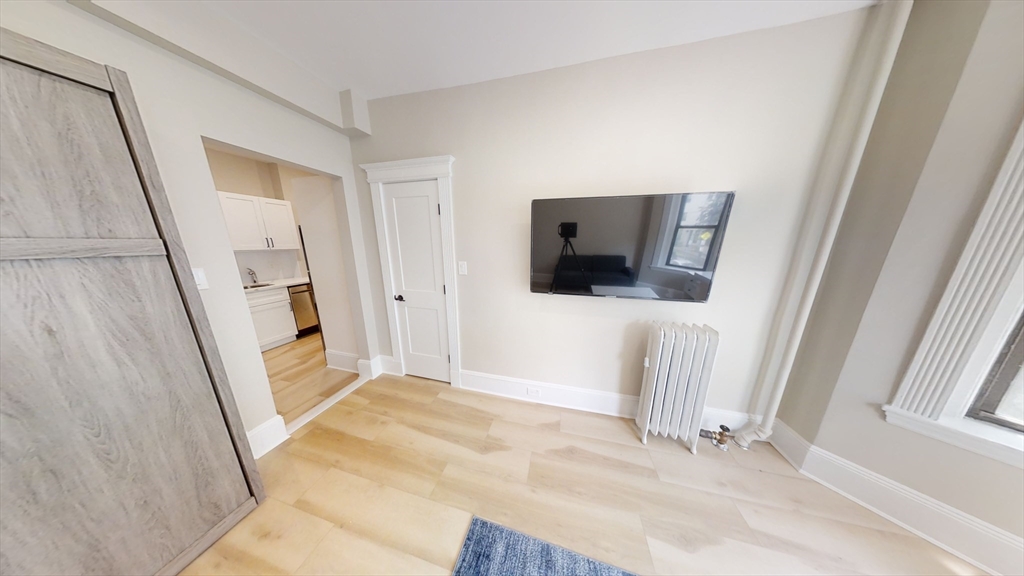 41 Edgerly Road, Unit 26 Boston, MA 02115 - Photo 2 of 9 a view of a livingroom with wooden floor and staircase