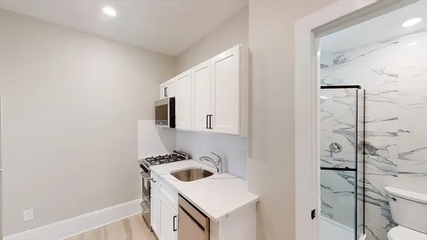 a bathroom with a sink and a washer dryer