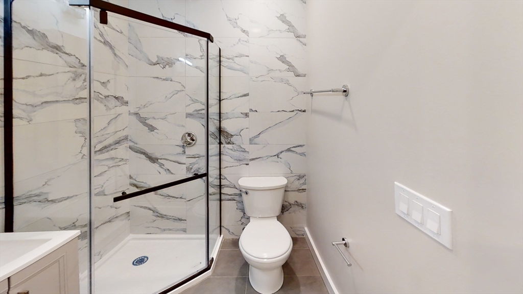41 Edgerly Road, Unit 26 Boston, MA 02115 - Photo 6 of 9 a bathroom with a toilet and a shower