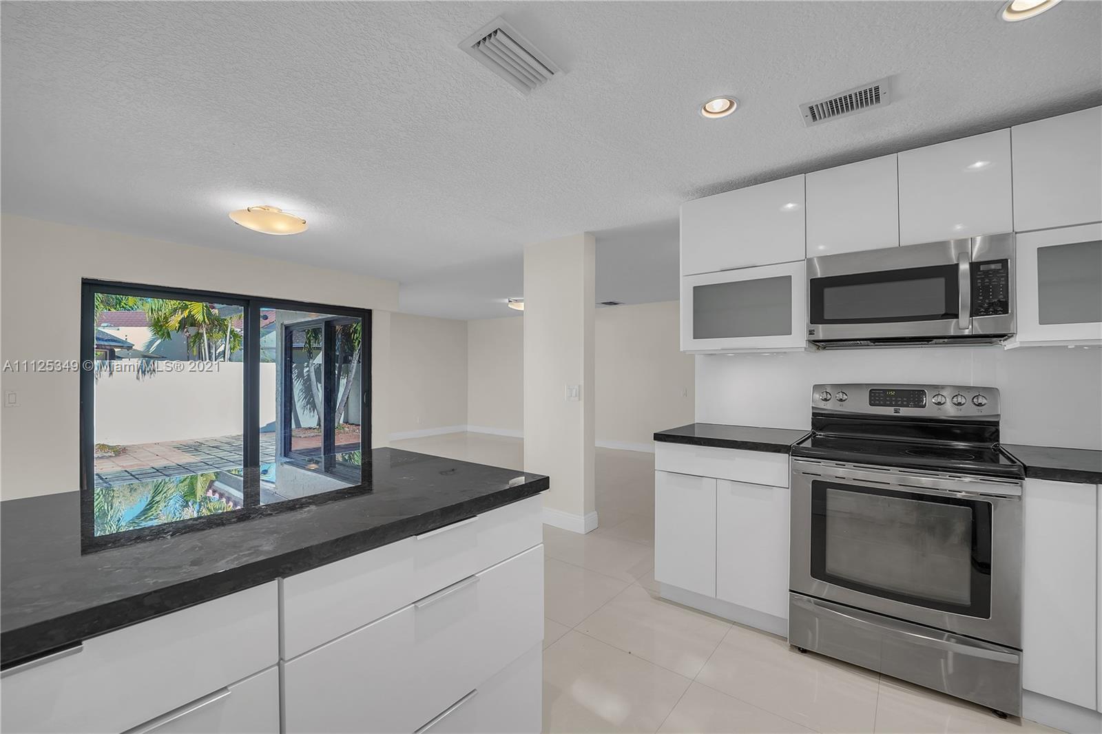 The Crossings Miami, FL 33186 - Photo 10 of 31 a kitchen with stainless steel appliances a stove sink and microwave