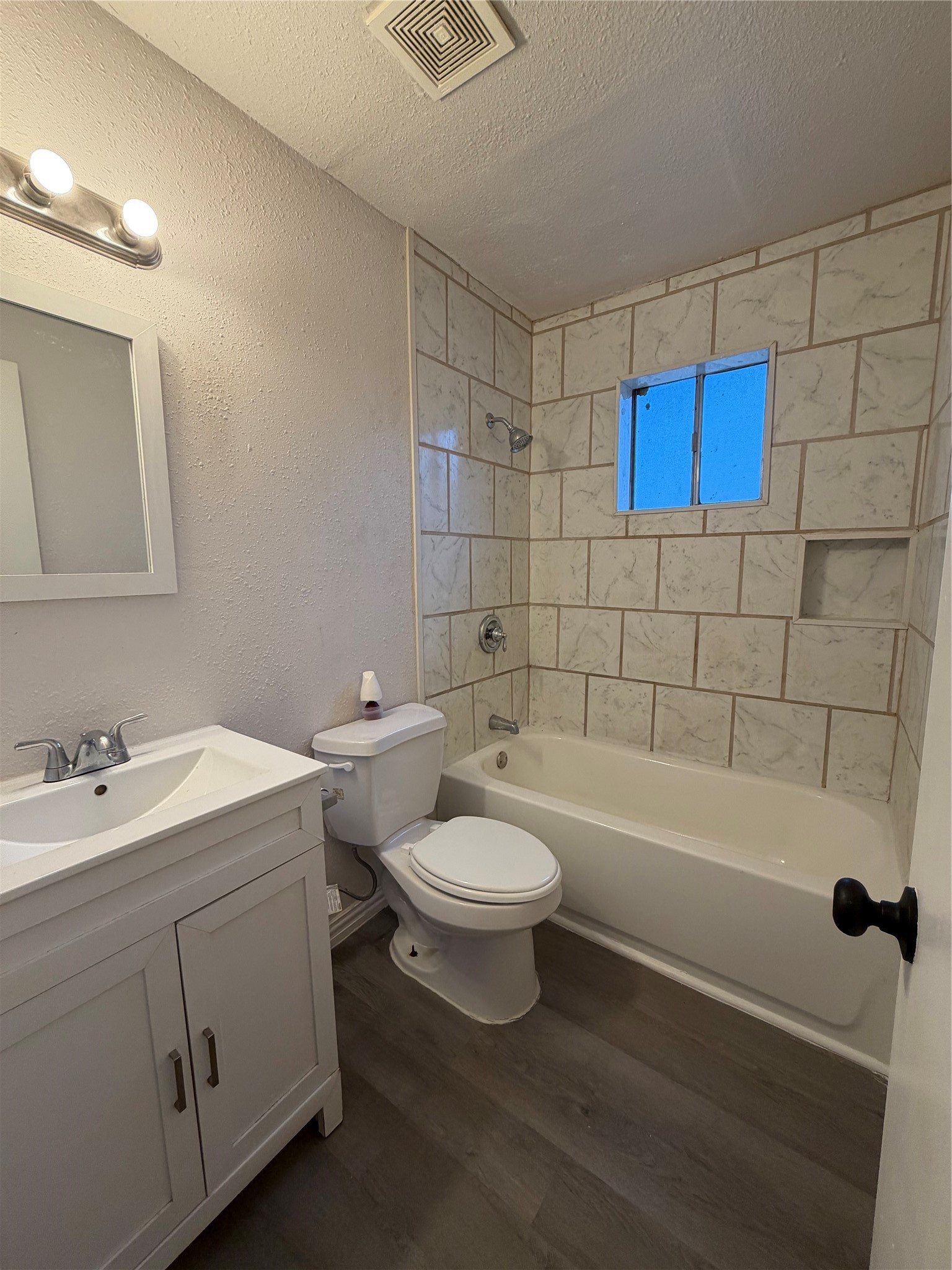 1614 Vauthier Street, Unit 3 La Marque, TX 77568 - Photo 9 of 13 a bathroom with a toilet a sink a mirror and bathtub