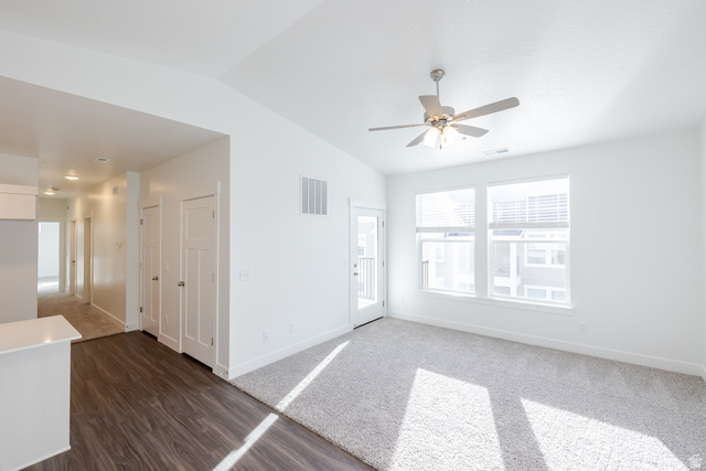 4662 Poplar Way, Unit Q302 Mapleton, UT 84664 - Photo 15 of 17 Unfurnished room with lofted ceiling, a ceiling fan, dark wood-style flooring, and dark carpet