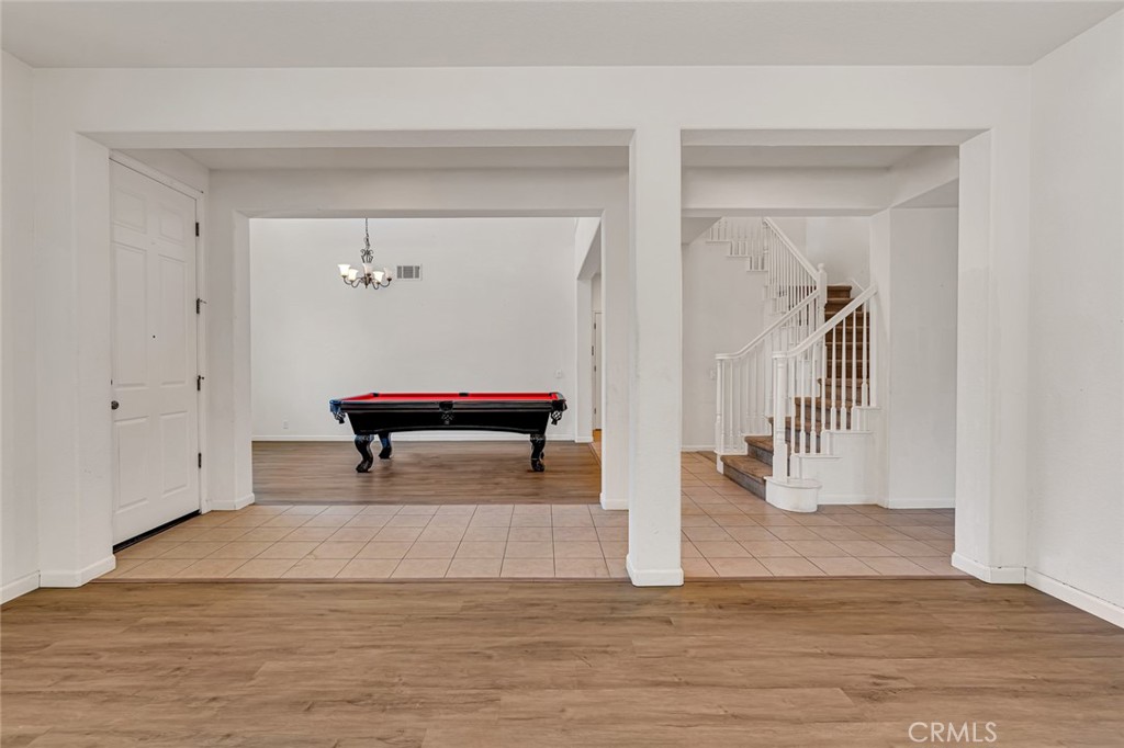 1289 Verdon Court Merced, CA 95348 - Photo 11 of 56 a view of a hallway with wooden floor and staircase