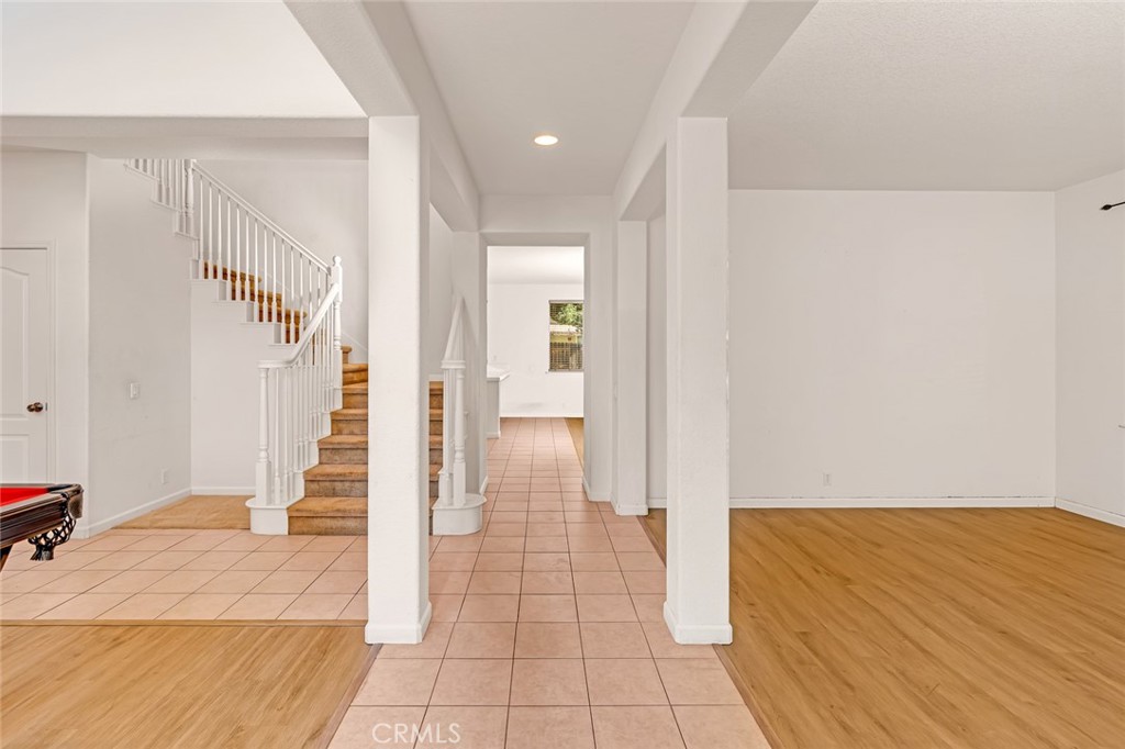 1289 Verdon Court Merced, CA 95348 - Photo 12 of 56 a view of a hallway with wooden floor and staircase