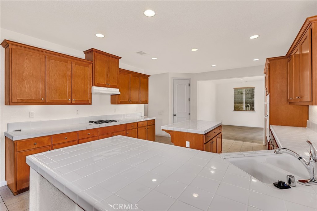 1289 Verdon Court Merced, CA 95348 - Photo 15 of 56 a kitchen with stainless steel appliances a sink stove and cabinets