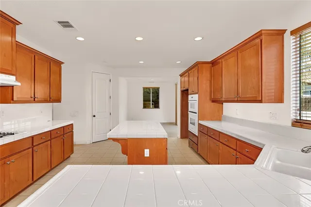 a view of kitchen with stainless steel appliances granite countertop a refrigerator and a sink
