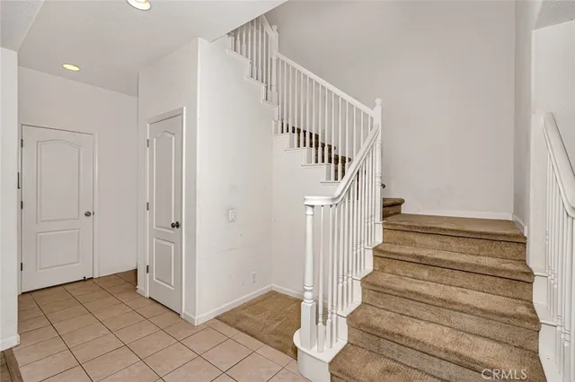 a bedroom with furniture and a large window