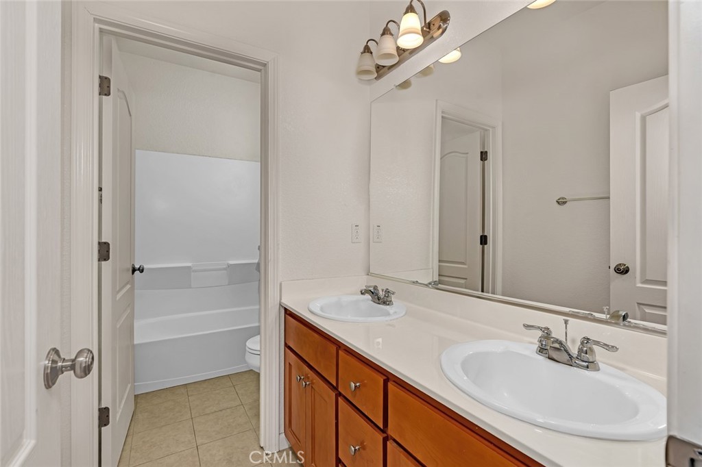 1289 Verdon Court Merced, CA 95348 - Photo 28 of 56 a bathroom with a sink double vanity and a mirror