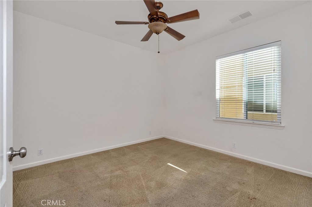 1289 Verdon Court Merced, CA 95348 - Photo 31 of 56 an empty room with a window and a fan