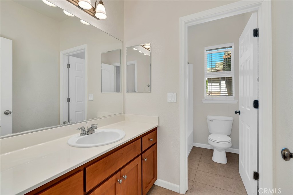 1289 Verdon Court Merced, CA 95348 - Photo 34 of 56 a bathroom with a sink a toilet a shower and a mirror
