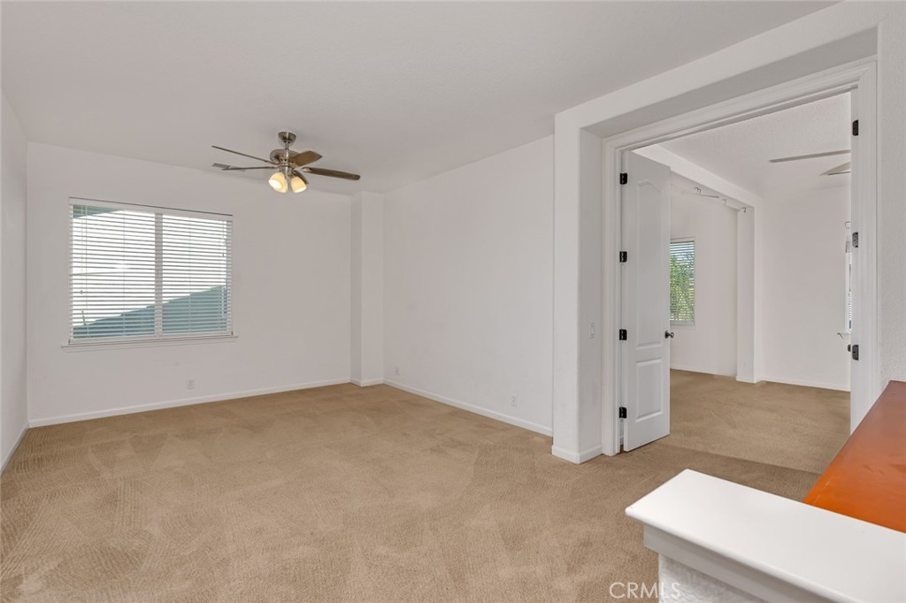 1289 Verdon Court Merced, CA 95348 - Photo 35 of 56 an empty room with windows and ceiling fan